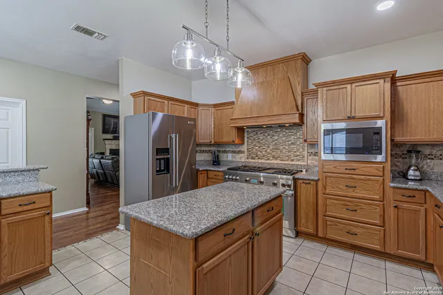 a living room with a bed and flat screen tv