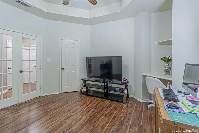a bathroom with a granite countertop sink a toilet and a mirror