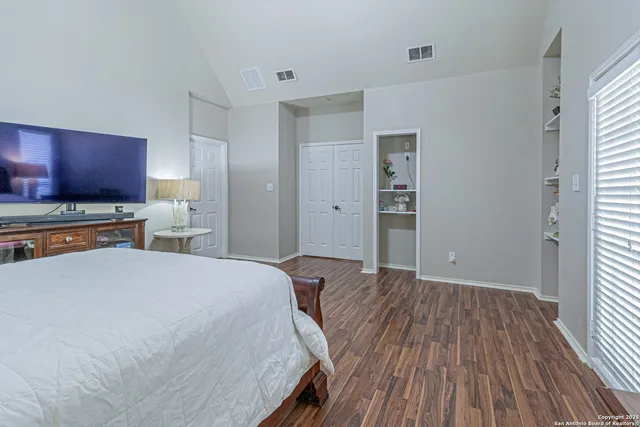 a view of a backyard with table and chairs and a large tree