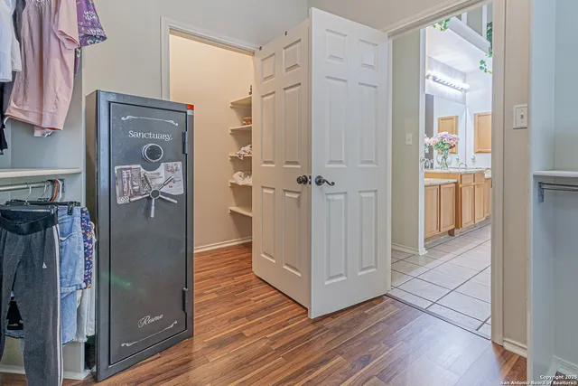 a view of a house with a yard and potted plants