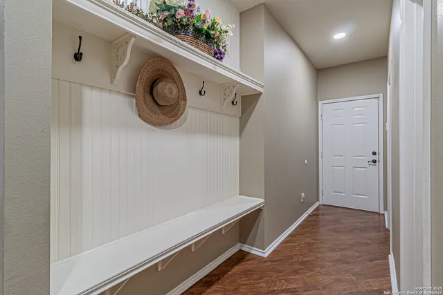 an aerial view of a house with a yard and large trees