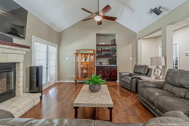 a living room with furniture and a fireplace