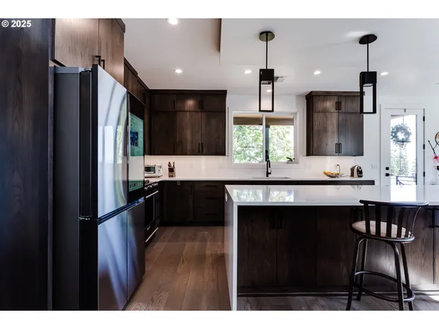 a kitchen with a sink stainless steel appliances and cabinets