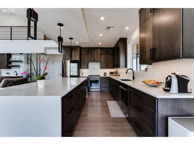 a large kitchen with stainless steel appliances kitchen island granite countertop a sink and cabinets