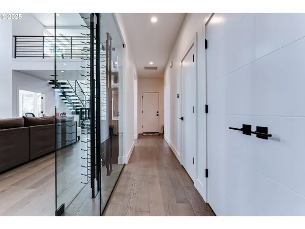 a view of a hallway with wooden floor