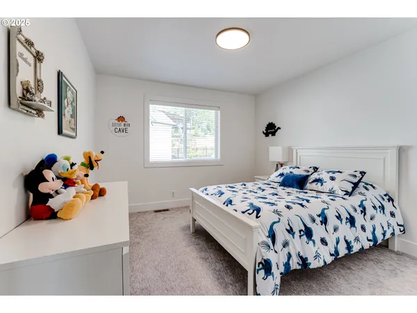 a bedroom with a bed and a dresser