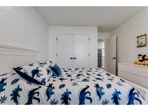 a bedroom with a bed and a dresser in it