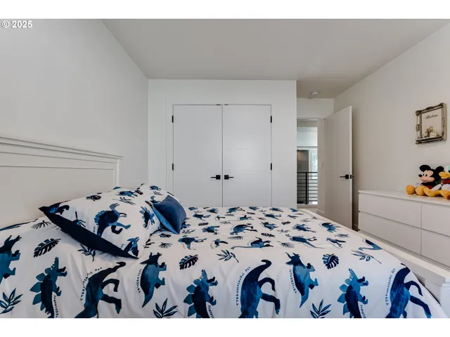 a bedroom with a bed and a dresser in it