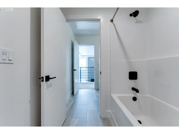 a bathroom with a bathtub a sink a vanity and shower