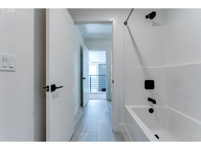 a bathroom with a bathtub a sink a vanity and shower