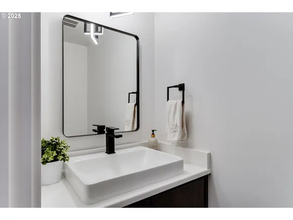 a bathroom with a sink a mirror and vanity