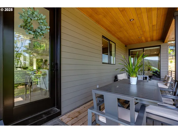 an aerial view of residential houses with outdoor space and trees all around