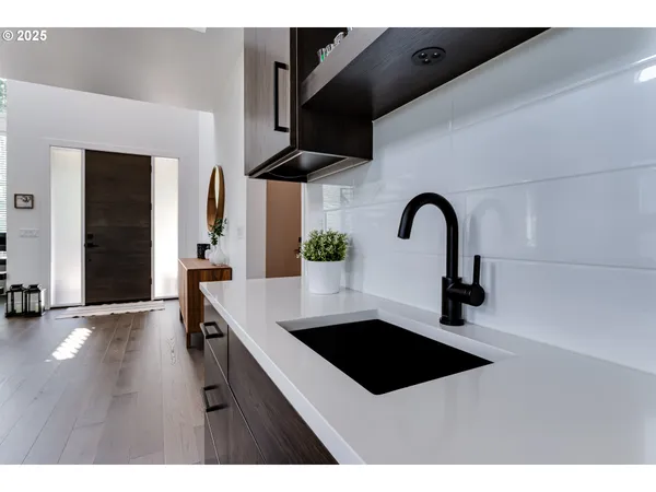 a kitchen with stainless steel appliances a sink a counter space and cabinets