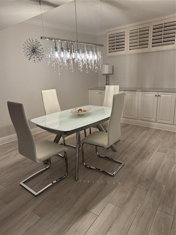 100 Sands Point Road, Unit 223 Longboat Key, FL 34228 - Photo 4 of 16 a view of a dining room with furniture and chandelier