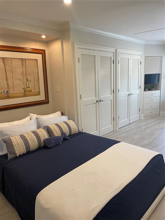 100 Sands Point Road, Unit 223 Longboat Key, FL 34228 - Photo 9 of 16 a bedroom with a bed and a window