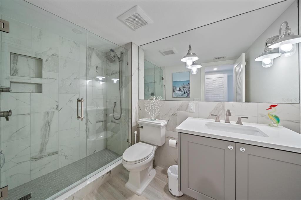 100 Sands Point Road, Unit 223 Longboat Key, FL 34228 - Photo 10 of 16 a bathroom with a sink a toilet and shower