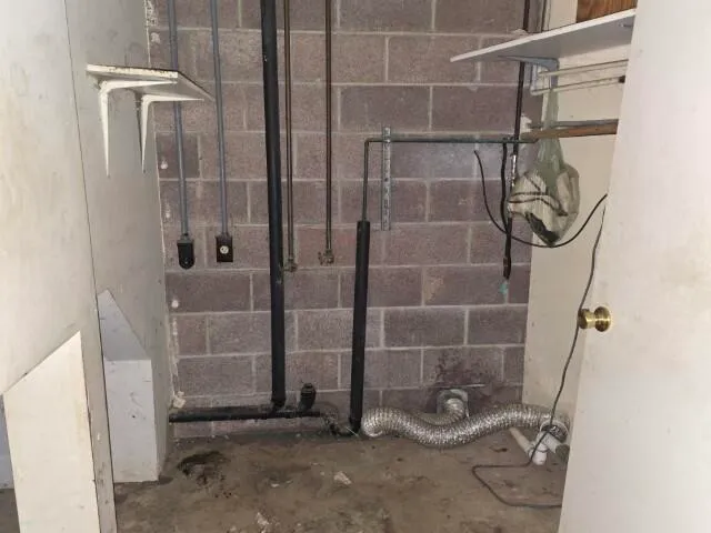 a view of a hallway with furniture and a window