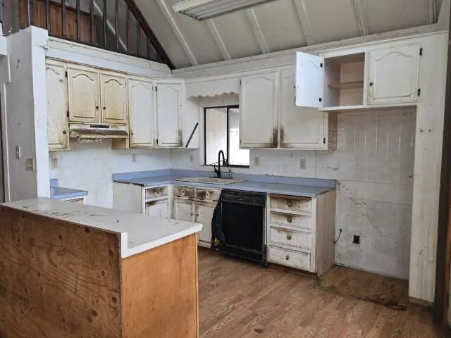 a hallway with a chair and wooden floor