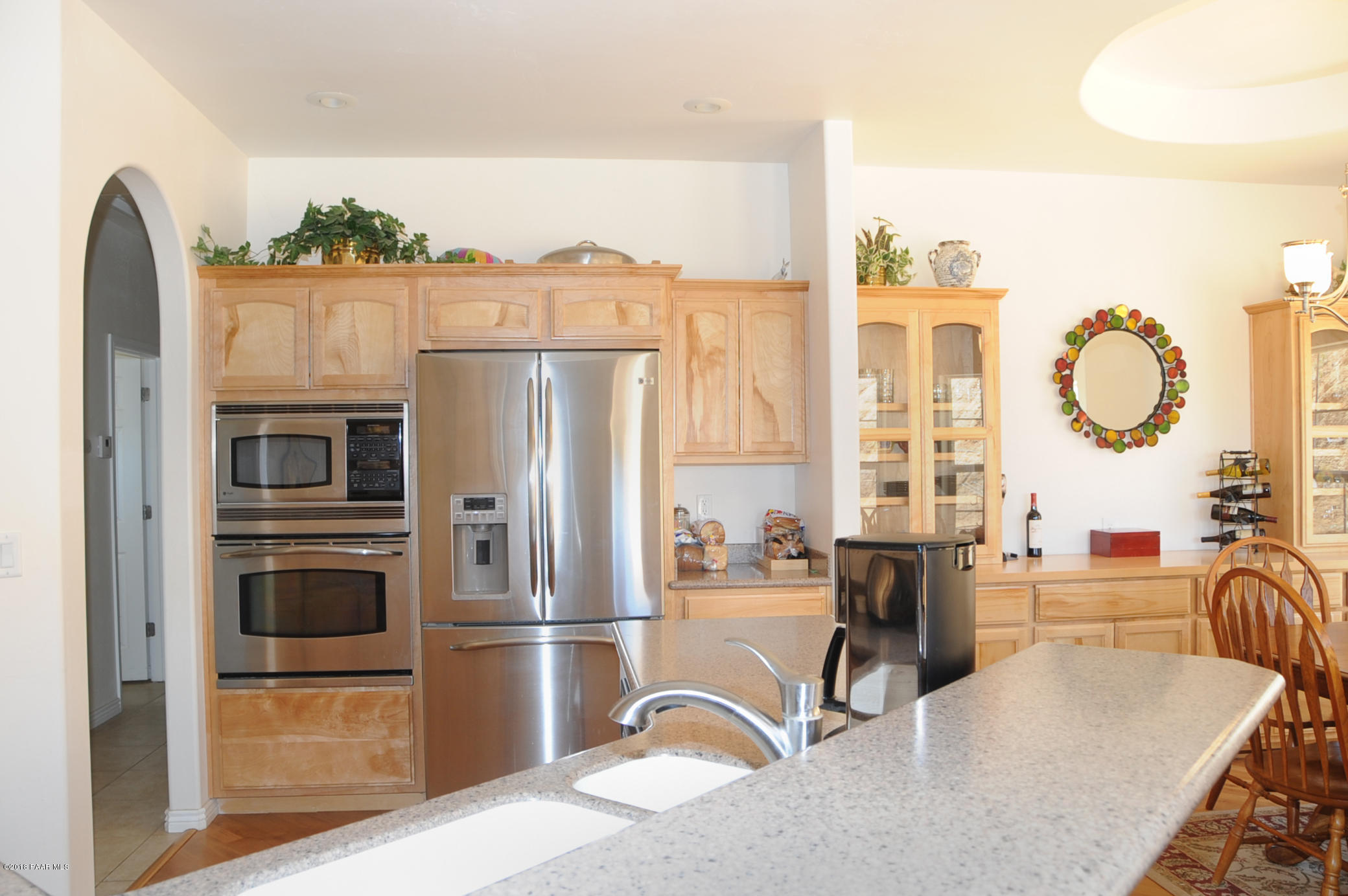 17675 East Rocking J Lane Dewey, AZ 86327 - Photo 5 of 10 a kitchen with stainless steel appliances granite countertop a refrigerator a stove and a dining table with wooden floor