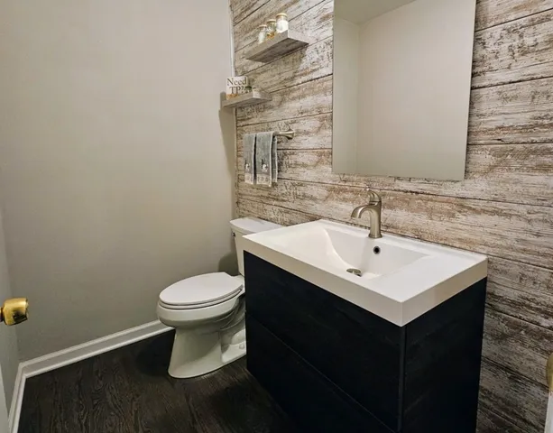 a bathroom with a sink toilet and mirror