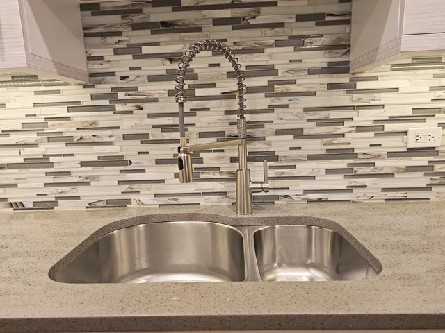 a kitchen with a sink and cabinets