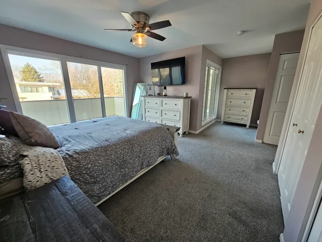 a living room with a bed furniture and a large window