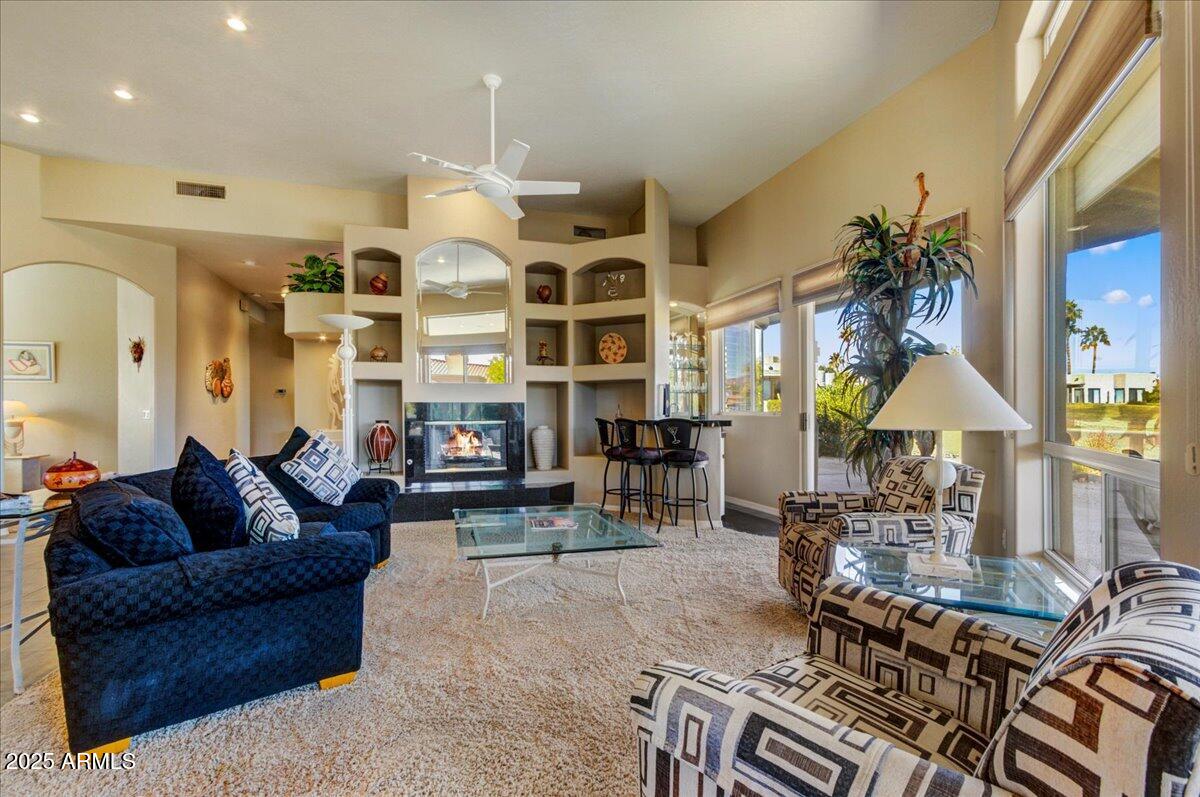 25633 North Abajo Drive Rio Verde, AZ 85263 - Photo 13 of 49 a living room with furniture a chandelier and a floor to ceiling window