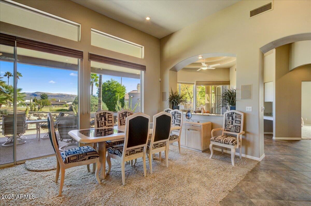 25633 North Abajo Drive Rio Verde, AZ 85263 - Photo 15 of 49 a dining room with furniture large windows and a rug