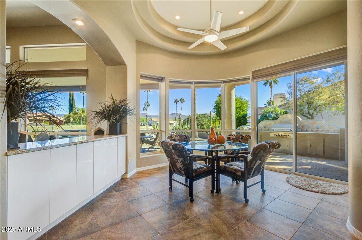 25633 North Abajo Drive Rio Verde, AZ 85263 - Photo 17 of 49 a view of a dining room with furniture large windows and wooden floor