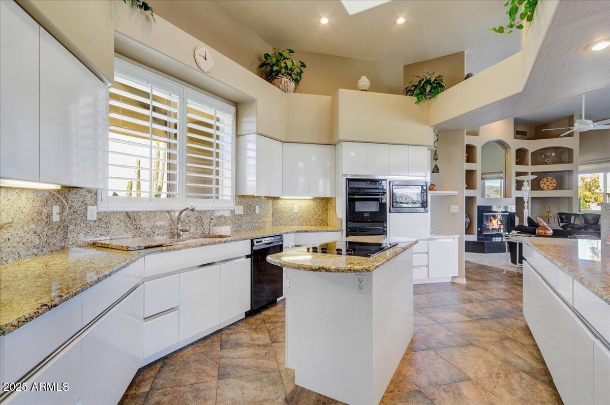 25633 North Abajo Drive Rio Verde, AZ 85263 - Photo 18 of 49 a kitchen with stainless steel appliances granite countertop a sink and a stove
