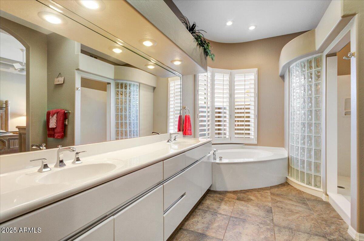 25633 North Abajo Drive Rio Verde, AZ 85263 - Photo 24 of 49 a bathroom with a tub a sink and a large mirror
