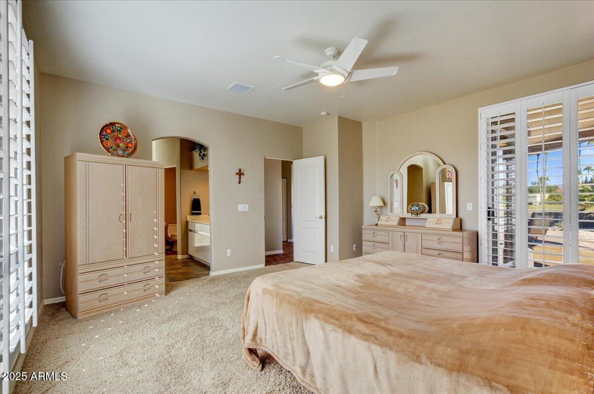 25633 North Abajo Drive Rio Verde, AZ 85263 - Photo 26 of 49 a bedroom with a bed and a chandelier