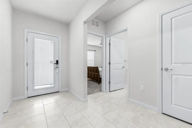 an empty room with closet and mirror