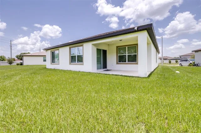 a view of a house with a yard and garage