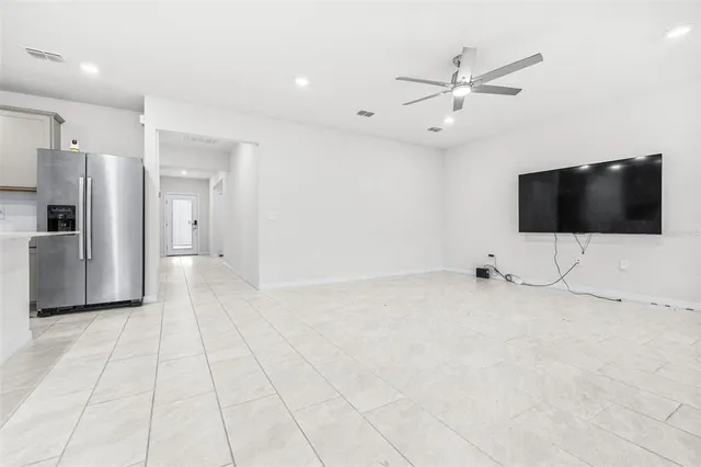 a view of a livingroom with an empty space and a ceiling fan