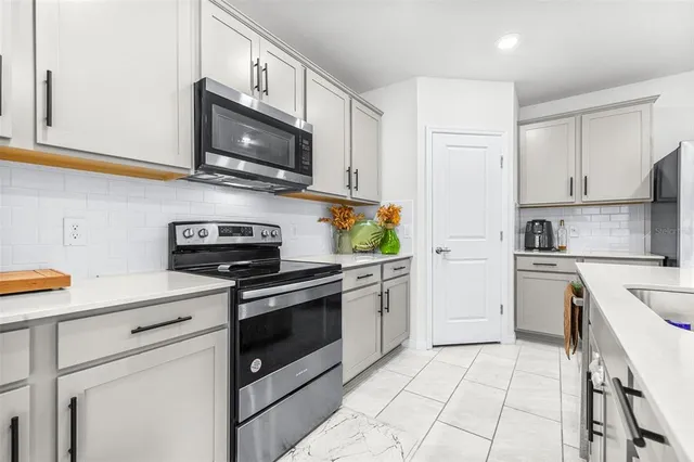 a kitchen with cabinets stainless steel appliances and wooden cabinets