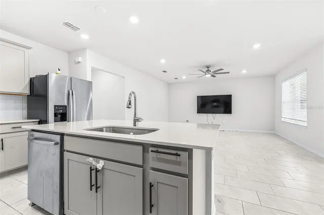 a kitchen with a sink and refrigerator