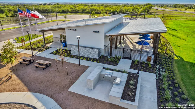 aerial view of a swimming pool with a yard and seating area