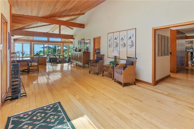 a dining room with furniture floor to ceiling windows and plants