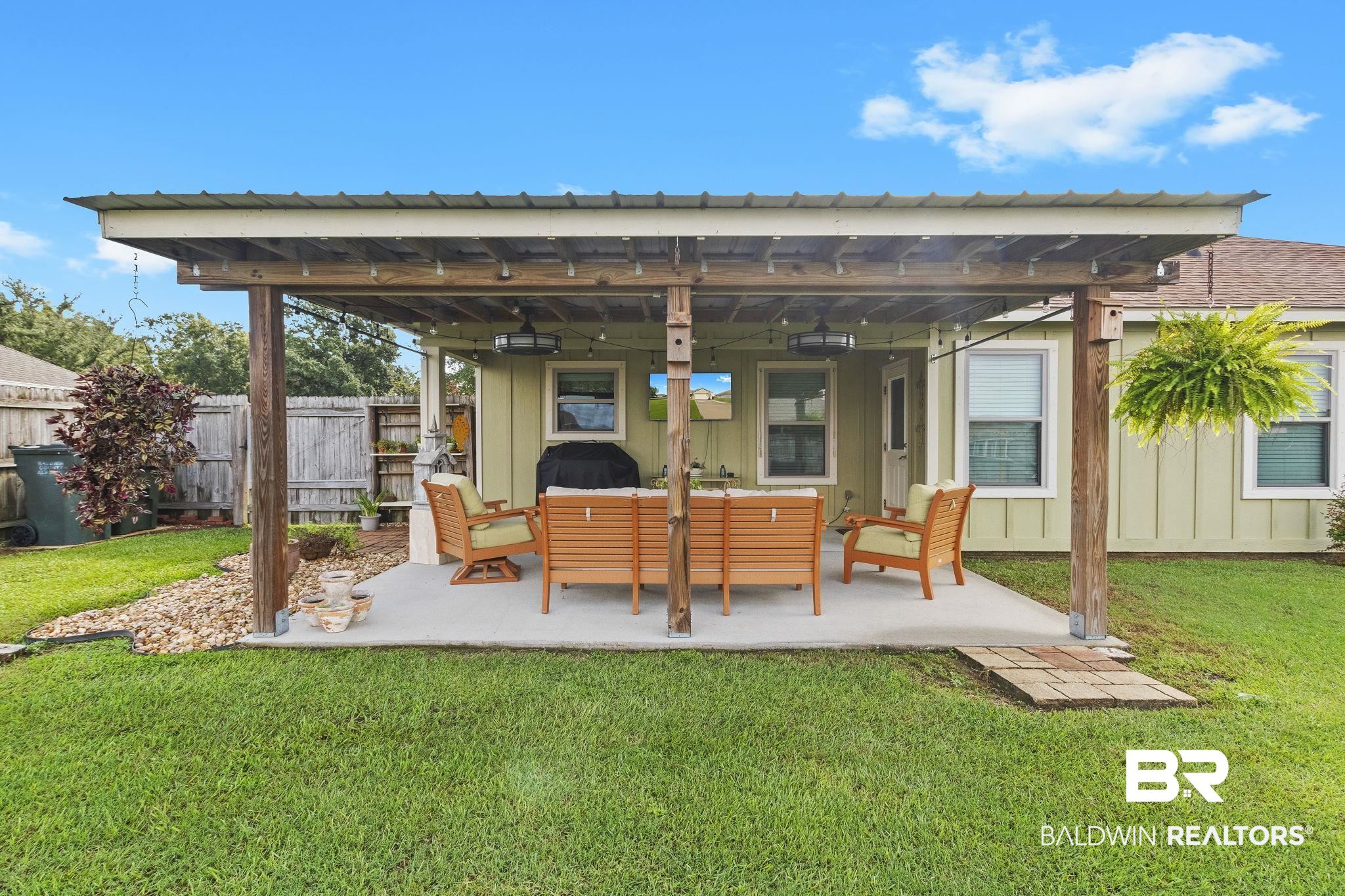 203 Lakefront Circle Summerdale, AL 36580 - Photo 69 of 69 Back of property with ceiling fan, outdoor lounge area, a yard, and a patio area