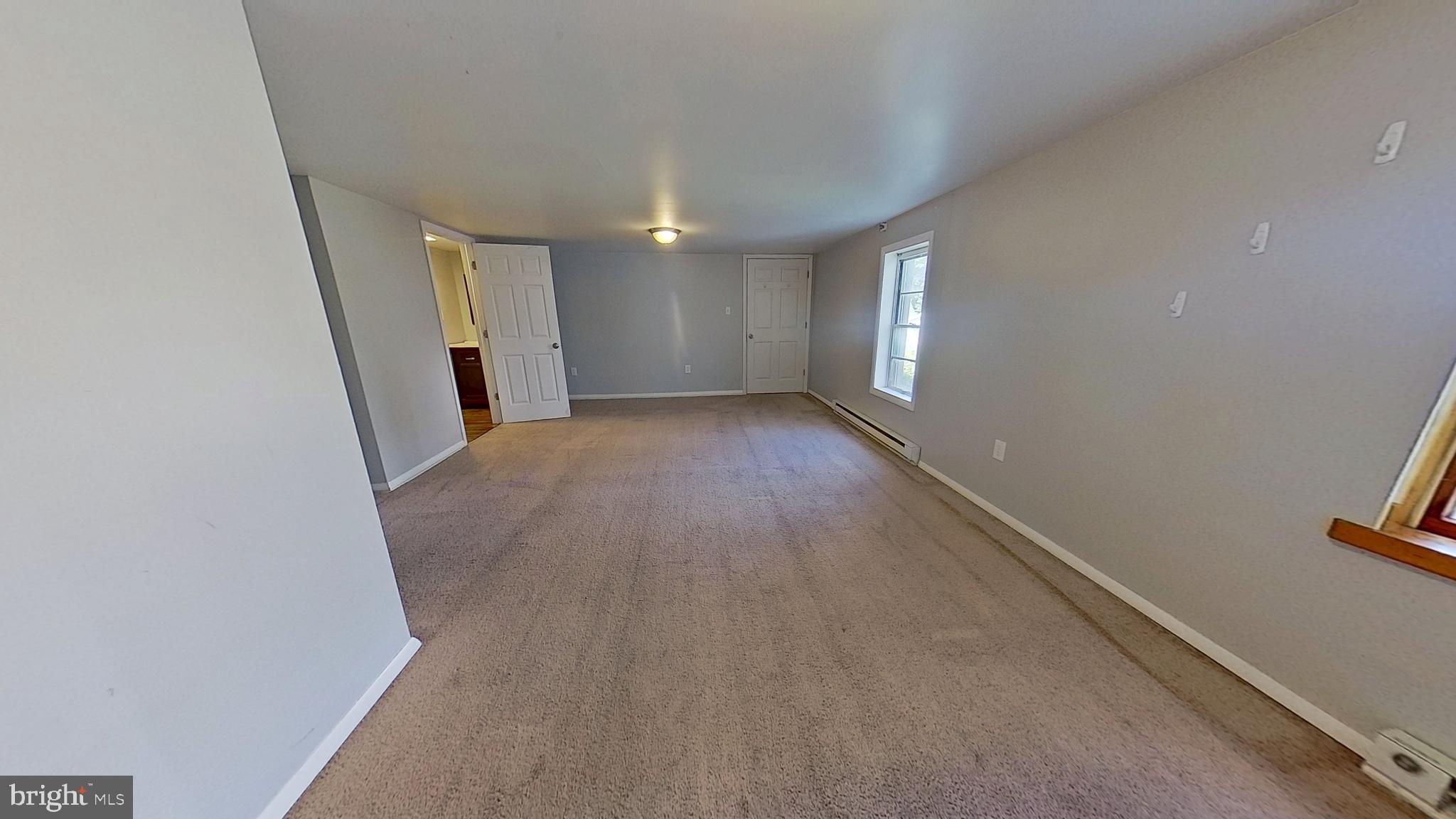 85 1st Avenue, Unit 1 Red Lion, PA 17356 - Photo 3 of 8 wooden floor in an empty room with a window