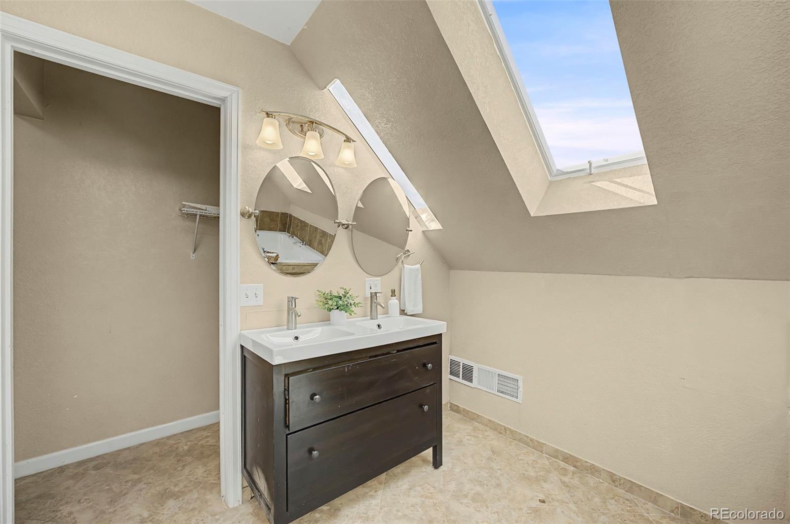 4394 South Van Gordon Way Morrison, CO 80465 - Photo 11 of 20 a bathroom with a sink and a mirror