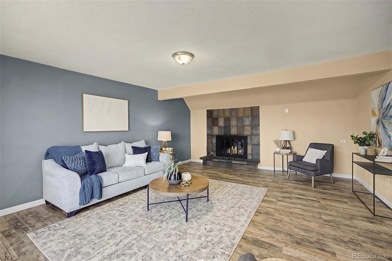 4394 South Van Gordon Way Morrison, CO 80465 - Photo 12 of 20 a living room with furniture and a fireplace