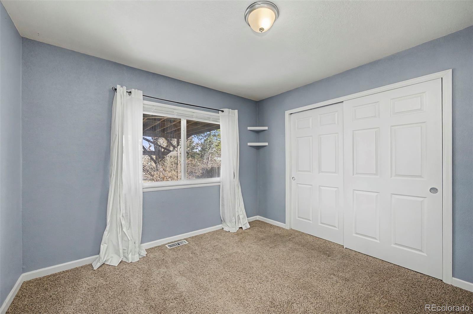 4394 South Van Gordon Way Morrison, CO 80465 - Photo 18 of 20 an empty room with windows