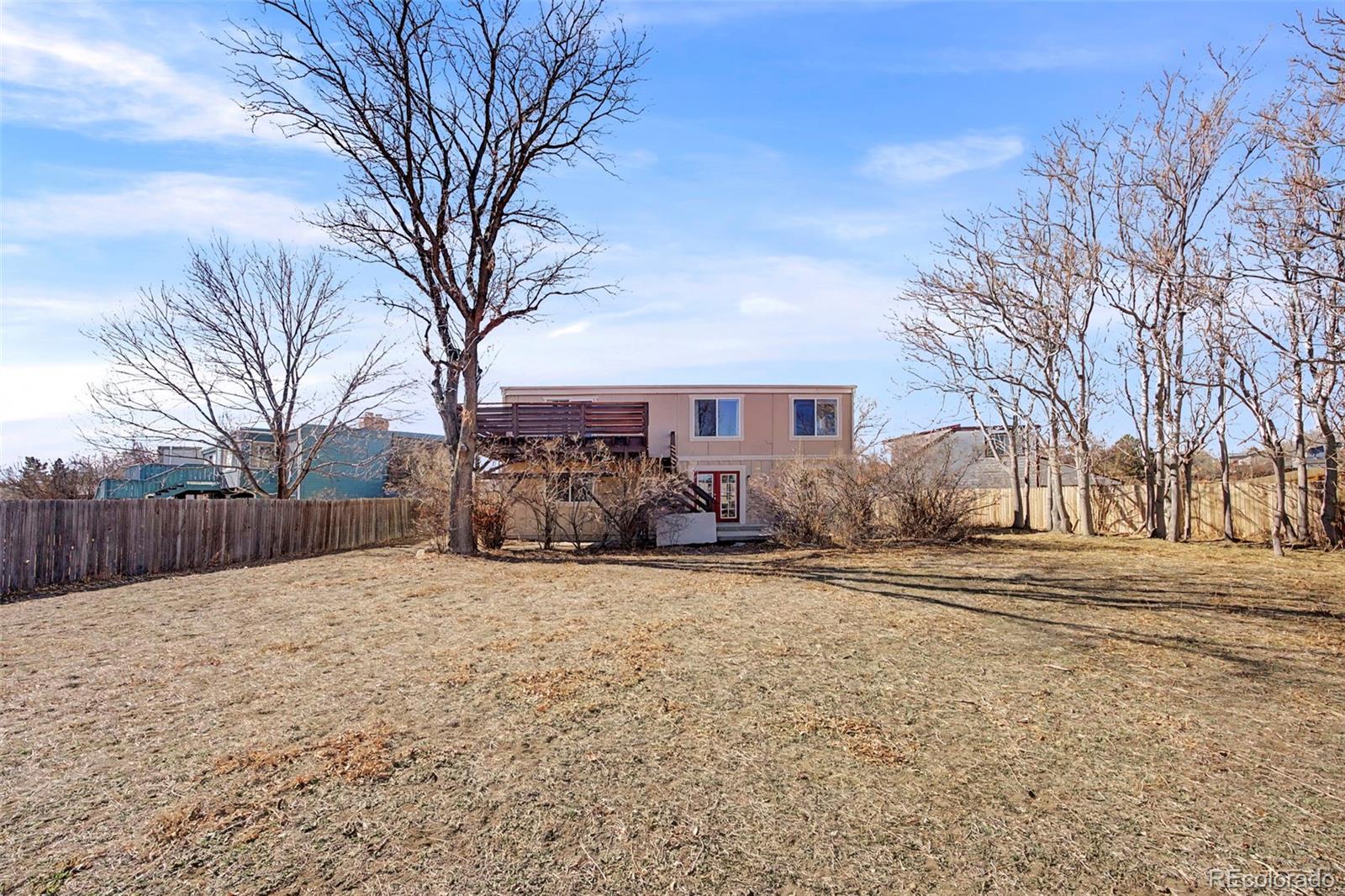 4394 South Van Gordon Way Morrison, CO 80465 - Photo 19 of 20 a front view of a house with a yard covered in snow