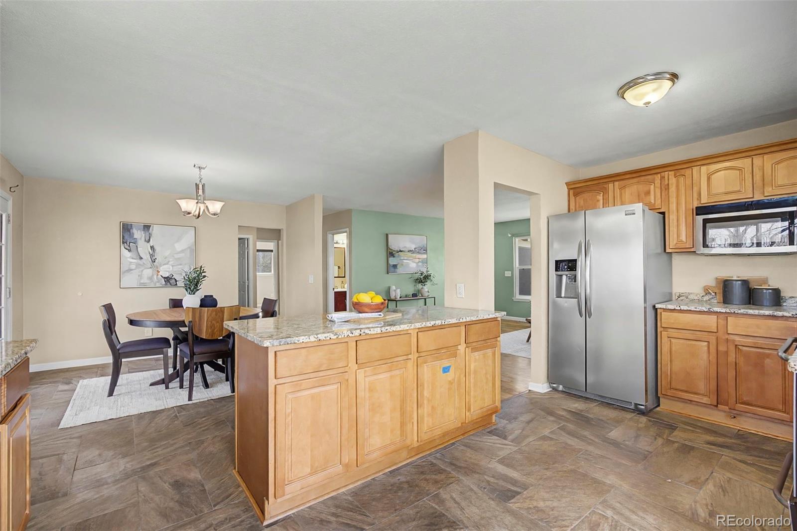4394 South Van Gordon Way Morrison, CO 80465 - Photo 7 of 20 a view of a kitchen that has a lot of cabinets and refrigerator