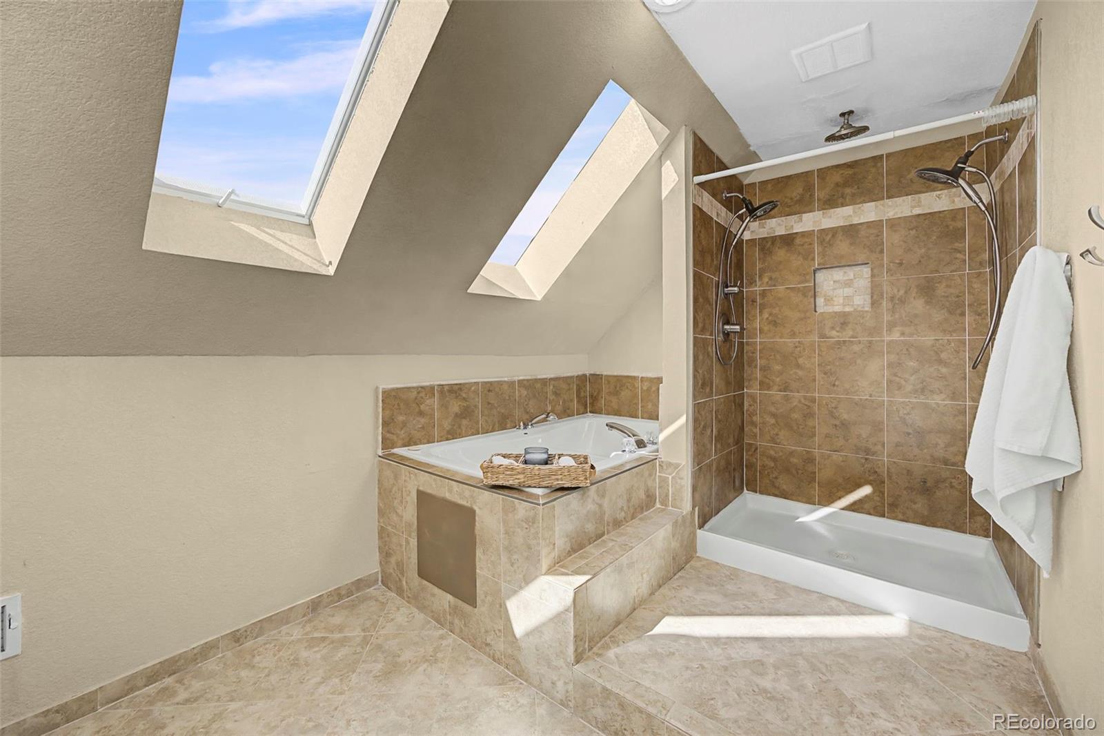 4394 South Van Gordon Way Morrison, CO 80465 - Photo 10 of 20 a bathroom with a tub a window and a shower