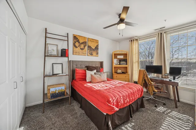 a bedroom with a bed and a desk