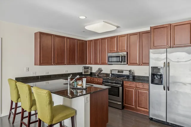 a kitchen with a stove a sink and a refrigerator