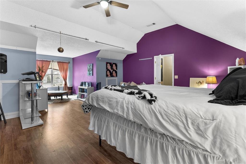 3234 Mineral Ridge Lane Stone Mountain, GA 30087 - Photo 38 of 55 a bed room with a bed and a chandelier